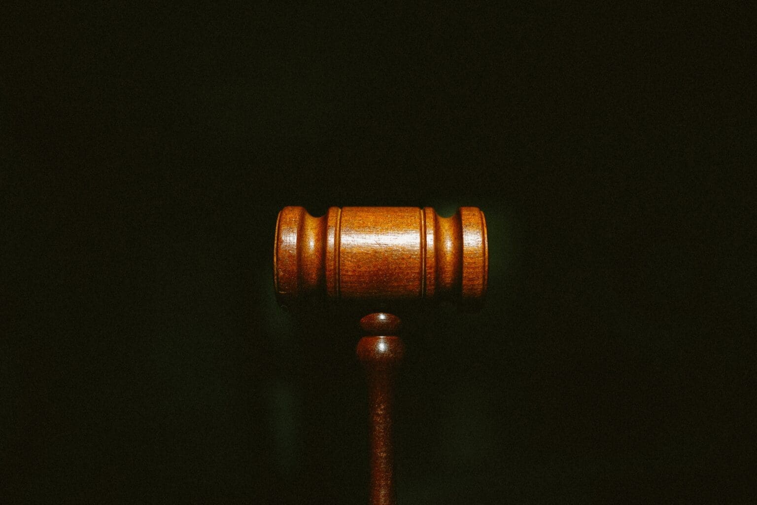 Small law gavel on black background