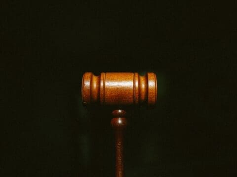 Small law gavel on black background