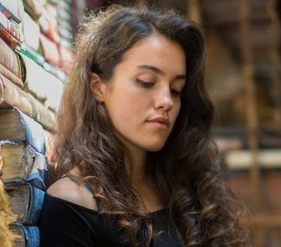 Young woman with long curl hair looking down