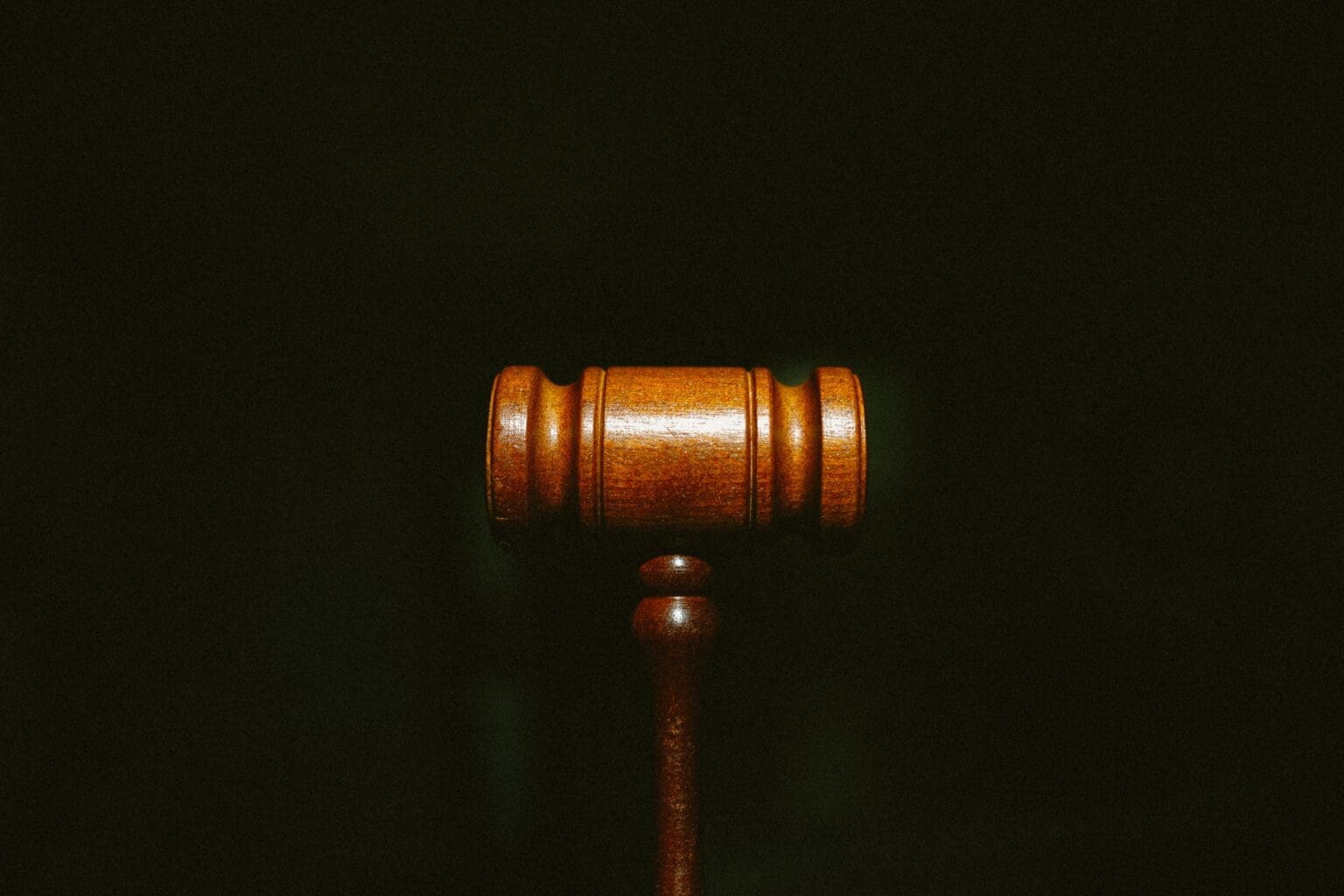 Small law gavel on black background